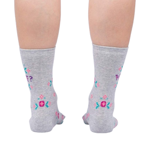 A pair of gray socks with a colorful floral pattern and the word 