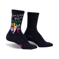 Black crew socks with a whimsical design. Features a carrot, radish, and turnip with faces, along with the text 'Rooting For You!'  Small pink dots are on the socks as well.
