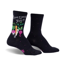 alt text: women's crew socks in black with pink polka dots and cartoon vegetables, including a carrot, beet, radish, and turnip, with the words "rooting for you" printed on them.  