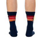 Rear view of navy blue Thunderstruck socks on a person's legs.