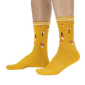 Lifestyle shot: A person's legs wearing the mustard yellow mushroom socks.