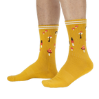 Lifestyle shot: A person's legs wearing the mustard yellow mushroom socks.
