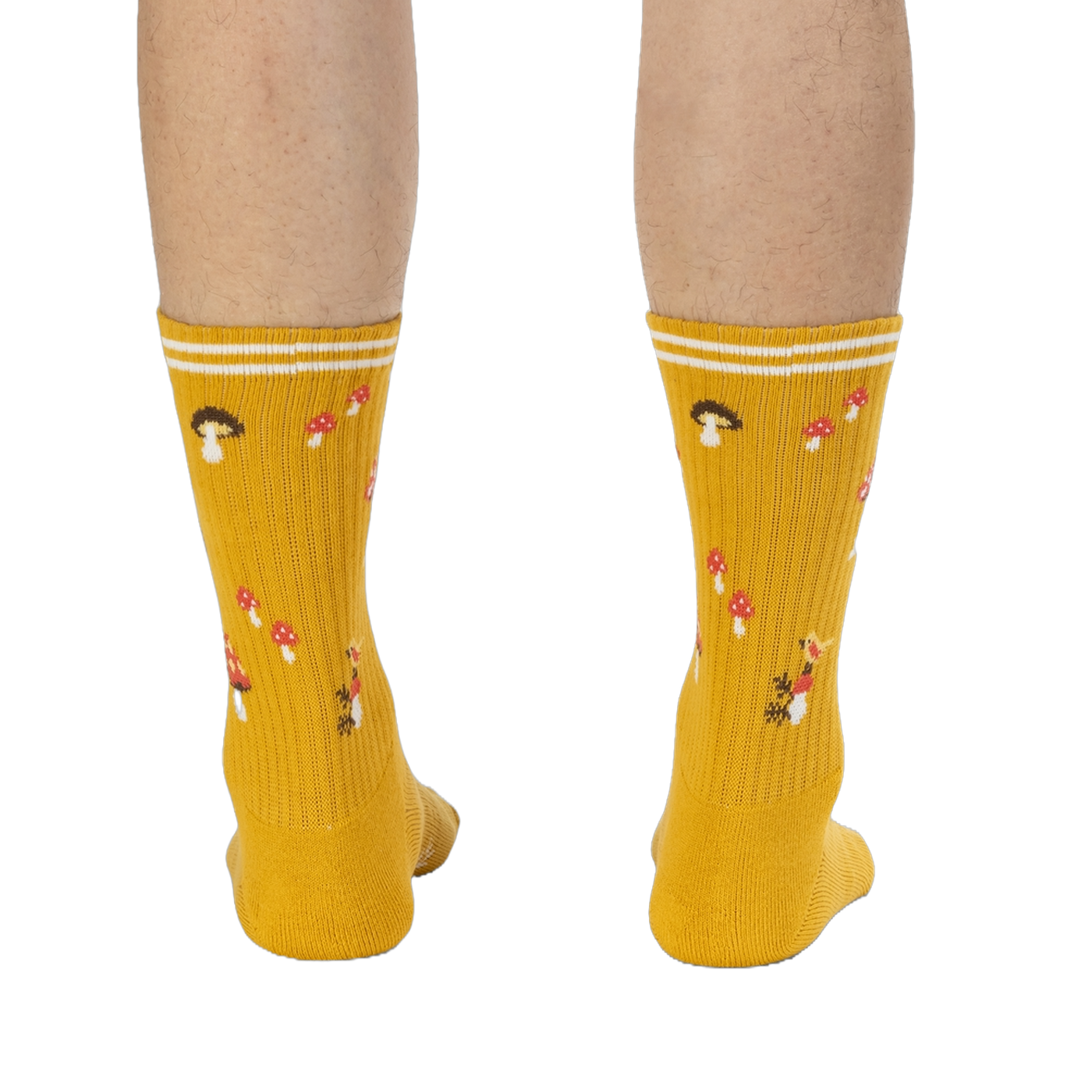 Rear view of the mustard yellow mushroom socks on a person's legs.