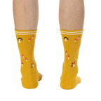 Rear view of the mustard yellow mushroom socks on a person's legs.
