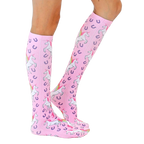 Lifestyle photo showcasing the pink unicorn socks on a person's legs, highlighting the sock's fit and pattern. [lf]