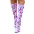 Close-up shot of the pink unicorn socks on a flat surface; highlighting the sock's color, design, and details. [lf]