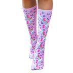 Close-up shot of the pink unicorn socks on a flat surface; highlighting the sock's color, design, and details. [lf]