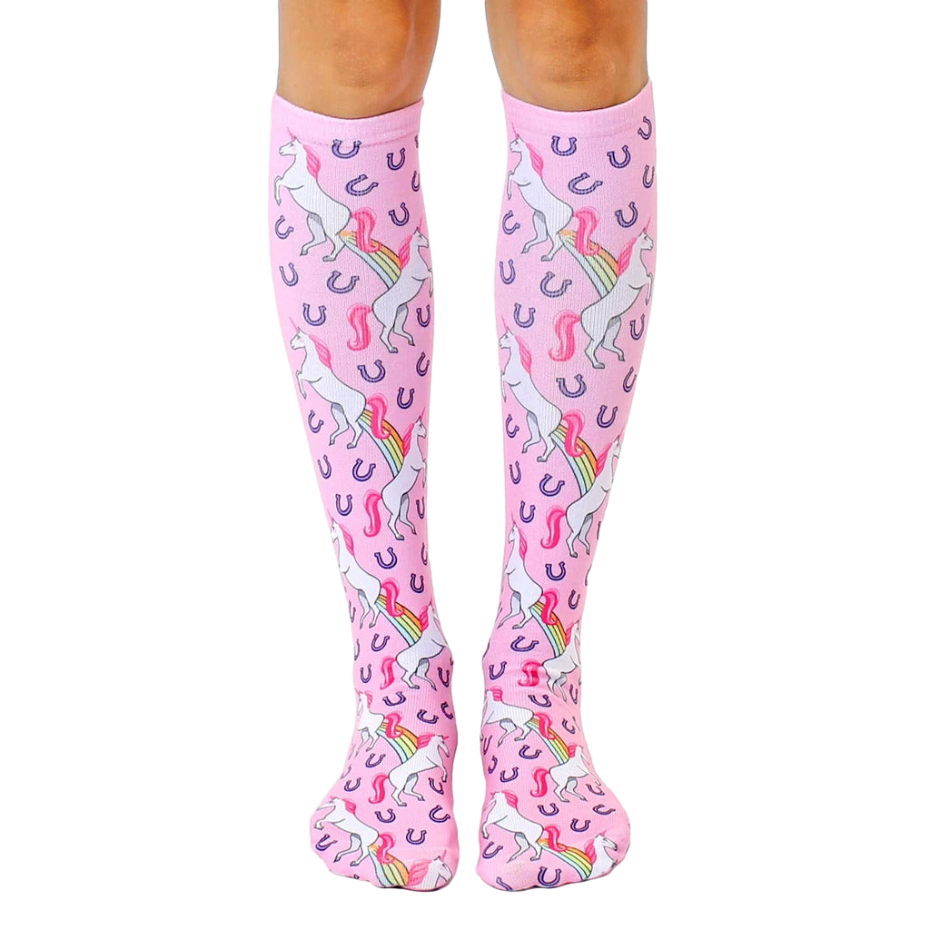 Pair of pink knee-high socks featuring a repeating pattern of white unicorns pooping rainbows and purple horseshoes. [lf]