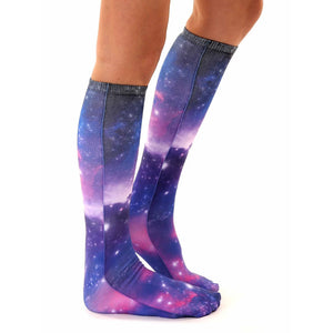 A pair of socks with a dark blue background and a colorful galaxy pattern of red, blue, and purple.