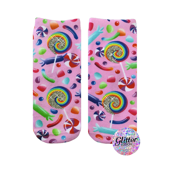 A pair of pink crew socks with a candy design.  Lollipops, gummy candies, and swirl candies are printed on a pink background with glitter accents. }}