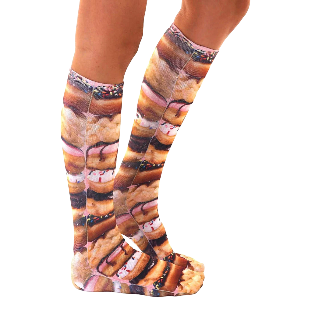 Lifestyle shot of Stacked Donut socks on a person's legs, showing the socks' length and design from a side angle. [lf]