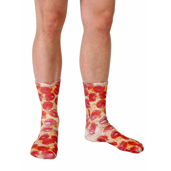 A person is wearing red low-top sneakers and socks that have a photorealistic pepperoni pizza pattern.