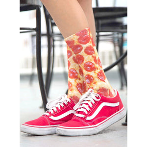 A person is wearing red low-top sneakers and socks that have a photorealistic pepperoni pizza pattern.