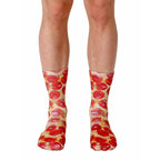 Pair of crew socks with a pepperoni pizza design.  Red, brown, and beige colors on a white background. [lf]