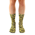 Lifestyle shot of a person's legs wearing the 'Caution' socks. The socks are the main focus, against a white background. [lf]
