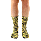 Lifestyle shot of a person's legs wearing the 'Caution' socks. The socks are the main focus, against a white background. [lf]
