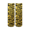 Pair of crew socks with a repeating caution tape pattern in black and yellow.  The design features the word 'CAUTION' printed on the tape.