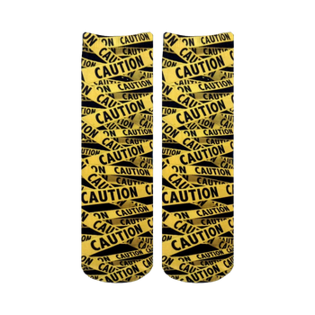 Pair of crew socks with a repeating caution tape pattern in black and yellow.  The design features the word 'CAUTION' printed on the tape.