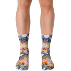 Crew socks showcasing a vibrant galaxy of adorable cat faces in various colors on a yellow-orange background. [lf]