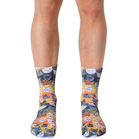 bright yellow socks feature cartoon cats in many colors and poses. unisex and crew length.  