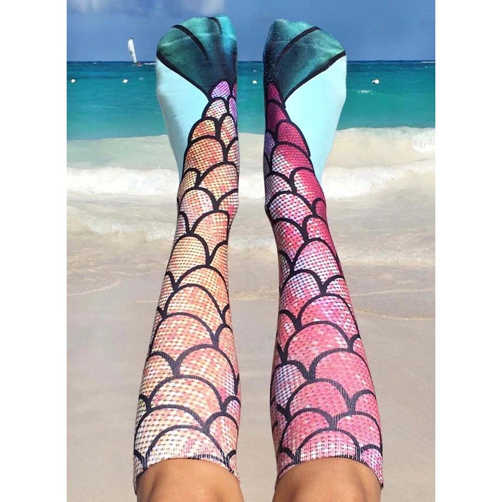 A pair of mermaid socks in a flat lay, showcasing the design detail. [lf]