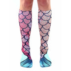 Pair of pink and teal knee-high socks featuring a mermaid tail scale design. [lf]