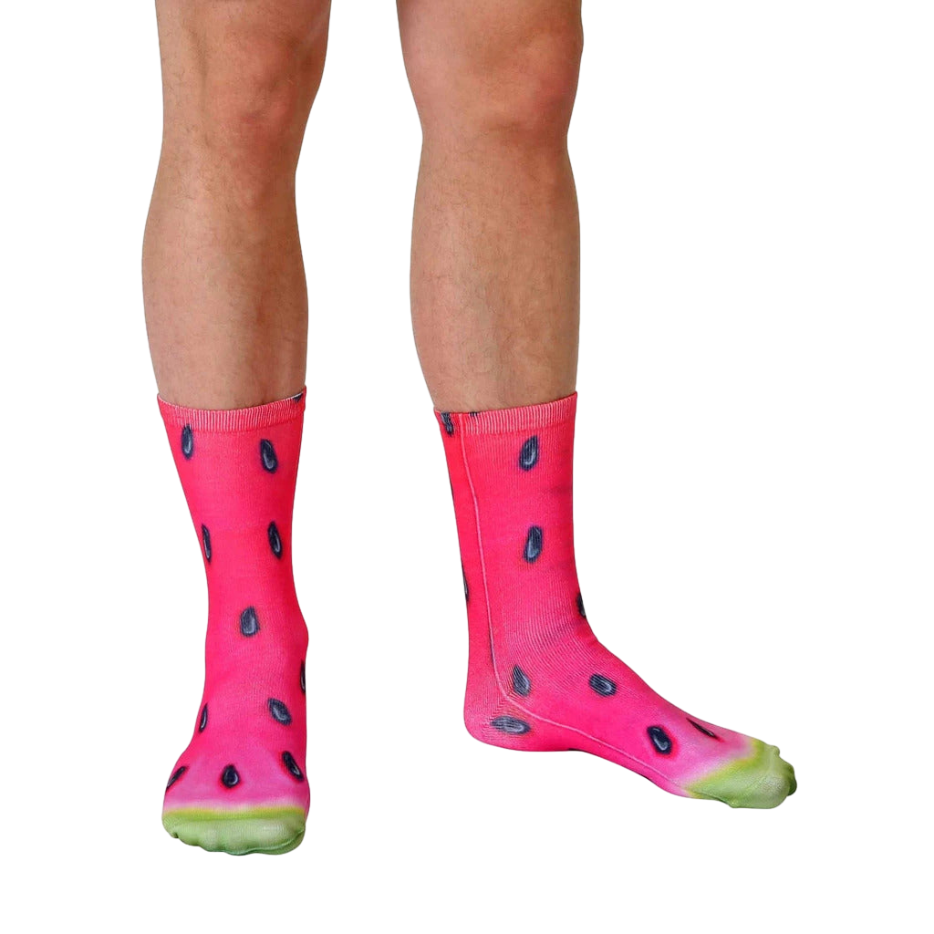Lifestyle photo of legs wearing the watermelon socks. The socks are shown on a person's feet, and are slightly angled. [lf]