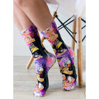 Flat lay image showing the socks, allowing a detailed view of the cat and food print against the space background. [lf]