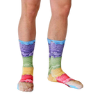 Lifestyle shot of a model's legs wearing the Ice Cream socks.  The socks are in focus against a white background. [lf]