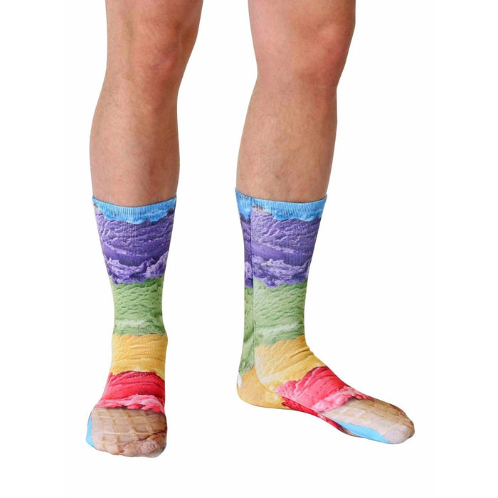 A pair of legs is shown from the knees down. The person is wearing a pair of socks that have a photorealistic image of rainbow sherbet ice cream with purple clouds in the background.