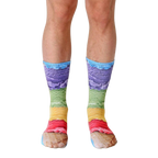A pair of crew socks with a vibrant ice cream cone design. The socks show layers of purple, green, yellow, and pink ice cream on a waffle cone. [lf]