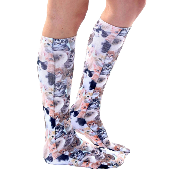 Lifestyle shot of a person wearing Kitty All Over knee-high socks, showcasing the fit and pattern. [lf]