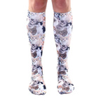 Knee-high socks with an all-over print of various kittens in shades of brown, black, white, and orange on a light blue background. [lf]