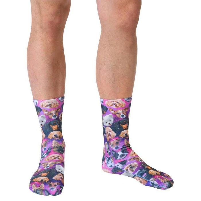 A pair of purple socks with a pattern of various dog breeds on them.