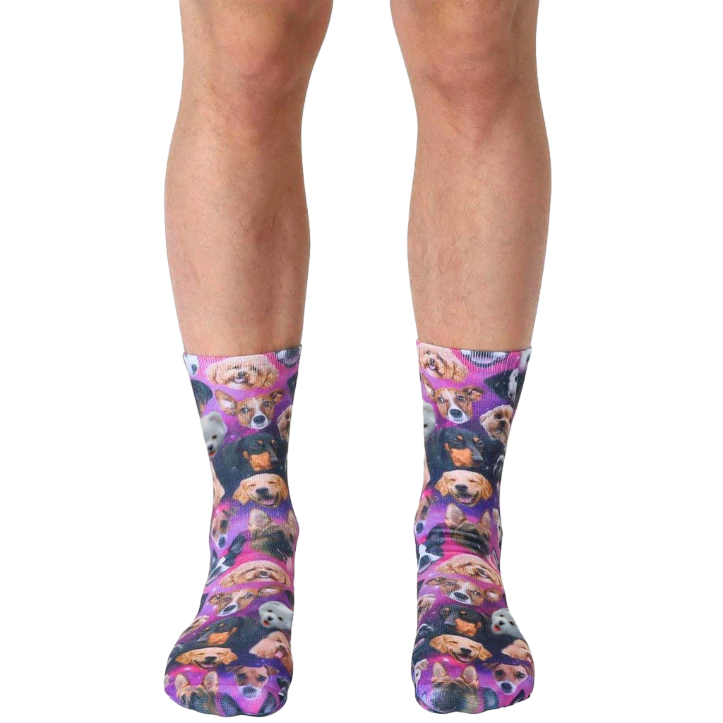 A pair of crew socks with a galaxy print featuring various breeds of dogs in a purple, pink, and black color scheme. [lf]