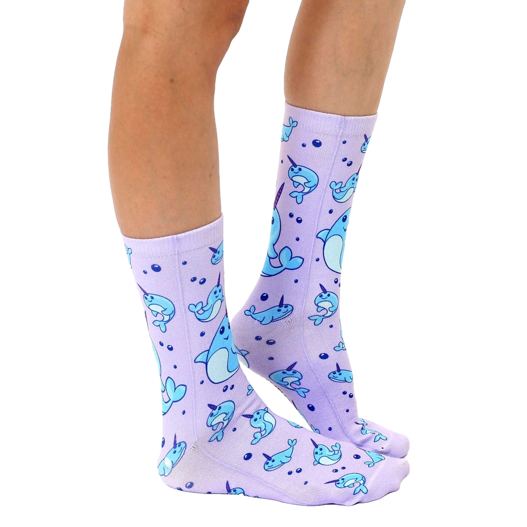Lifestyle shot showing the narwhal socks on a person's legs, showcasing how they look when worn. [lf]