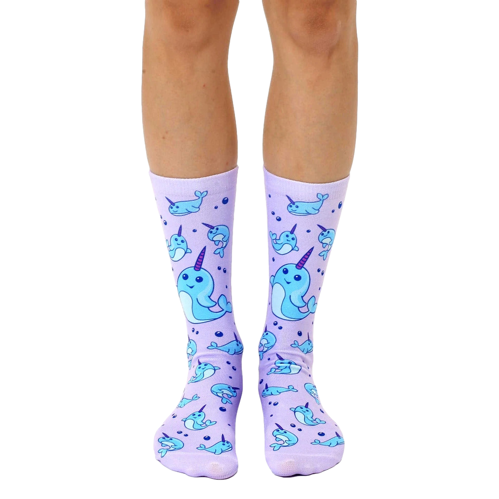 Lavender crew socks with a repeating pattern of light blue narwhals and bubbles. Fun and whimsical design. [lf]
