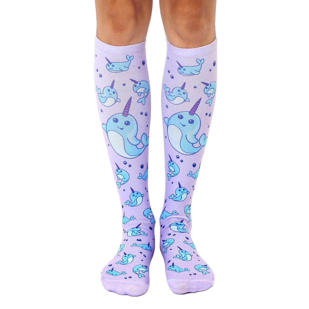 Pair of lavender knee-high socks with an all-over print of cute cartoon narwhals and bubbles. [lf]