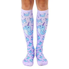 knee high purple socks with a repeating pattern of cartoon narwhals in blue with purple horns. for women.  