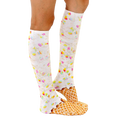 Lifestyle shot showing a person wearing the Rainbow Sprinkle Ice Cream knee-high socks. The socks are visible from the side. [lf]