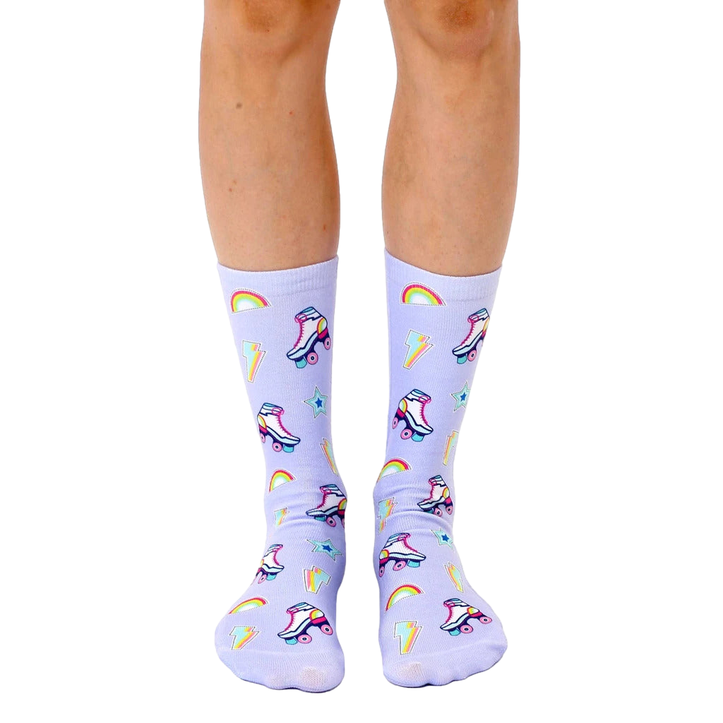 Pair of lavender crew socks with a playful pattern of retro roller skates, rainbows, and lightning bolts. [lf]