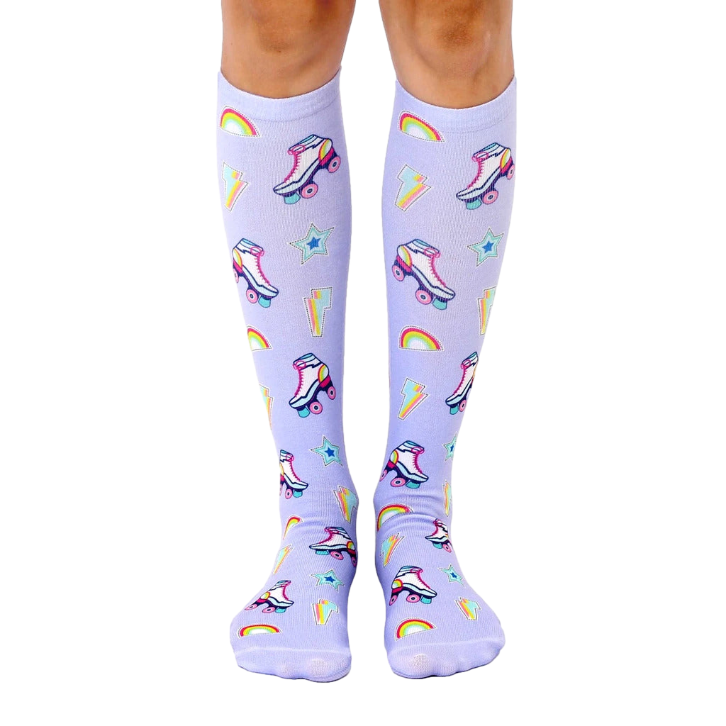 Pair of pastel purple knee-high socks with a fun pattern of retro roller skates, rainbows, lightning bolts, and stars. [lf]