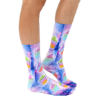 Lifestyle shot of model wearing the Slushie Universe socks; showing socks on feet, from the knees down. [lf]