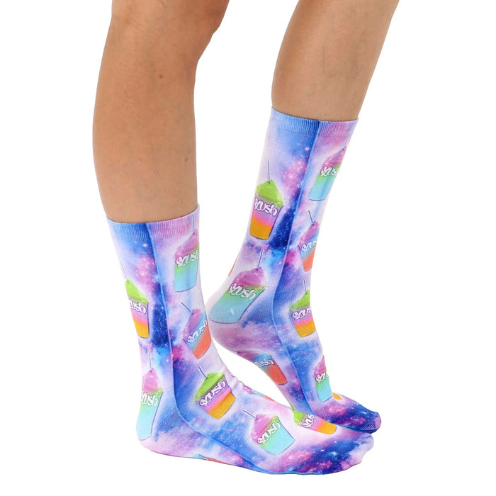 A pair of calf-high socks with an all-over pattern of cartoonish, galaxy-themed slushies in shades of purple, blue, and pink against a background of stars.