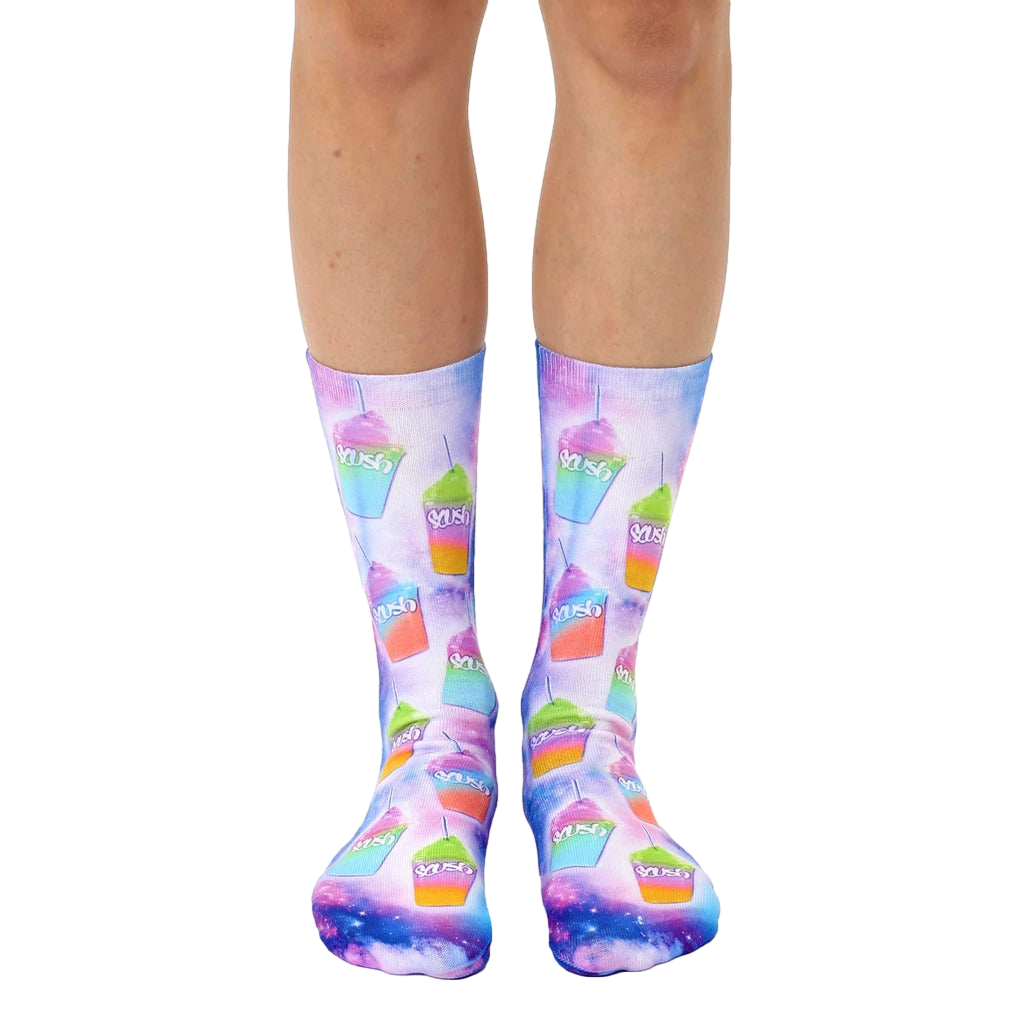 Pair of crew socks with a vibrant design of colorful slushies on a galaxy-print background. The slushies are pink, green, and orange. [lf]
