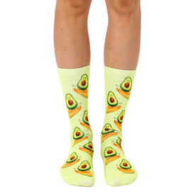 light green crew socks with an all-over pattern of dark and light green avocados with brown stems for men and women.   