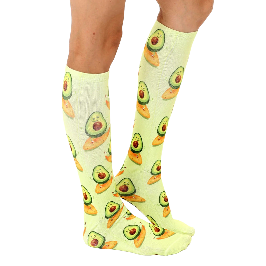 Lifestyle shot showing the socks on a person's legs, highlighting the length and fit of the Surfing Avocado socks. [lf]