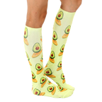 Lifestyle shot showing the socks on a person's legs, highlighting the length and fit of the Surfing Avocado socks. [lf]