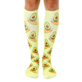 Pair of light green knee-high socks with a repeating pattern of cartoon avocados surfing. [lf]