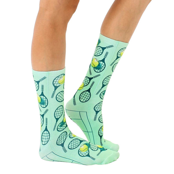 Lifestyle shot of a person's legs wearing the mint green tennis socks. [lf]